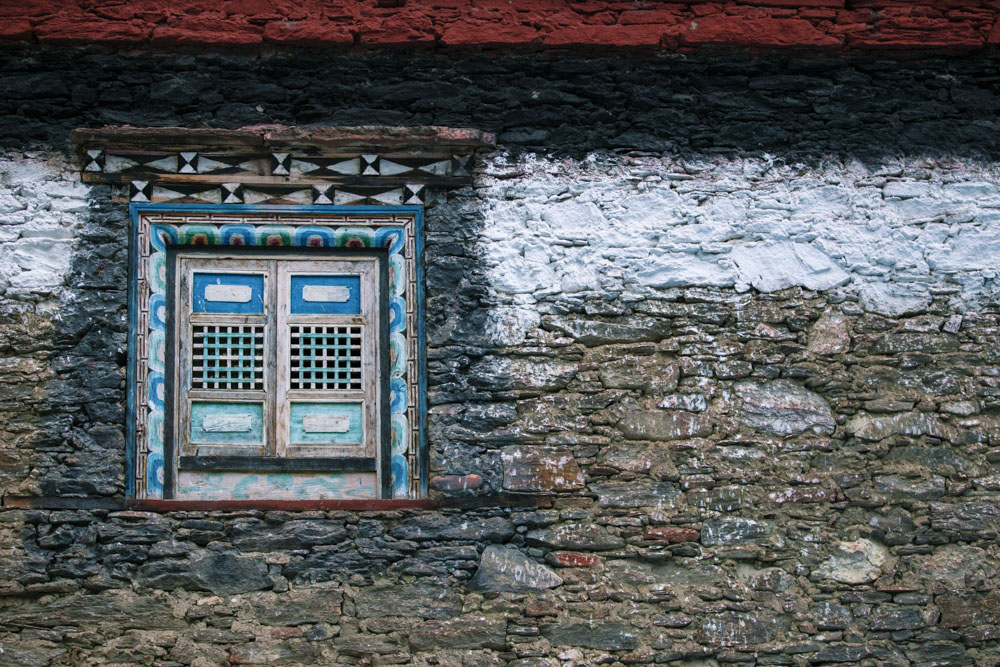 藏族建筑的特点：厚墙、小窗，常常使用红、黄、白、蓝、黑、绿等宗教颜色点缀墙体。